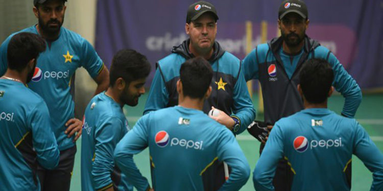 Pakistan's head coach Mickey Arthur speaks with his players during their World Cup campaign.