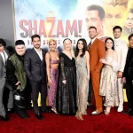 Grace Caroline Currey with movie of cast Shazam 2 Fury of the Gods premiere